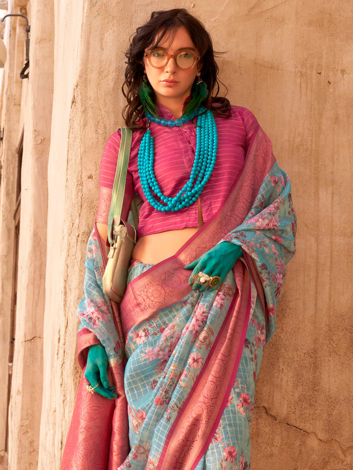 This Sky Blue–Magenta FeatherSoft saree features stunning printed floral work with floral detailing and grid textures, ideal for festive evenings and cocktail-ready styling. Designed for lightweight elegance and statement draping. SKU 376006. This Sky Blue–Magenta FeatherSoft saree features stunning printed floral work with floral detailing and grid textures, ideal for festive evenings and cocktail-ready styling. Designed for lightweight elegance and statement draping. SKU 376006.