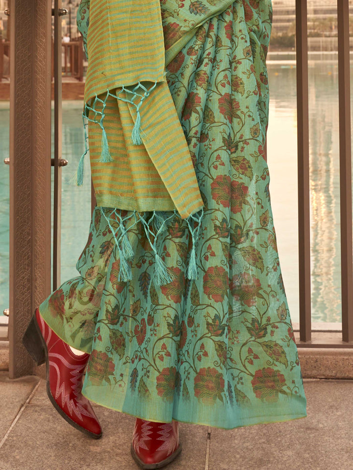 Sea Green and Golden zari tissue saree with printed floral motifs and zari pallu This image captures the back drape focus revealing pallu finesse and motif richness, ideal for visualizing festive elegance, designer appeal, and modern styling inspiration. Perfect for online shoppers seeking detailed previews before purchase, enhancing saree visual merchandising and SEO-rich product display strategy.