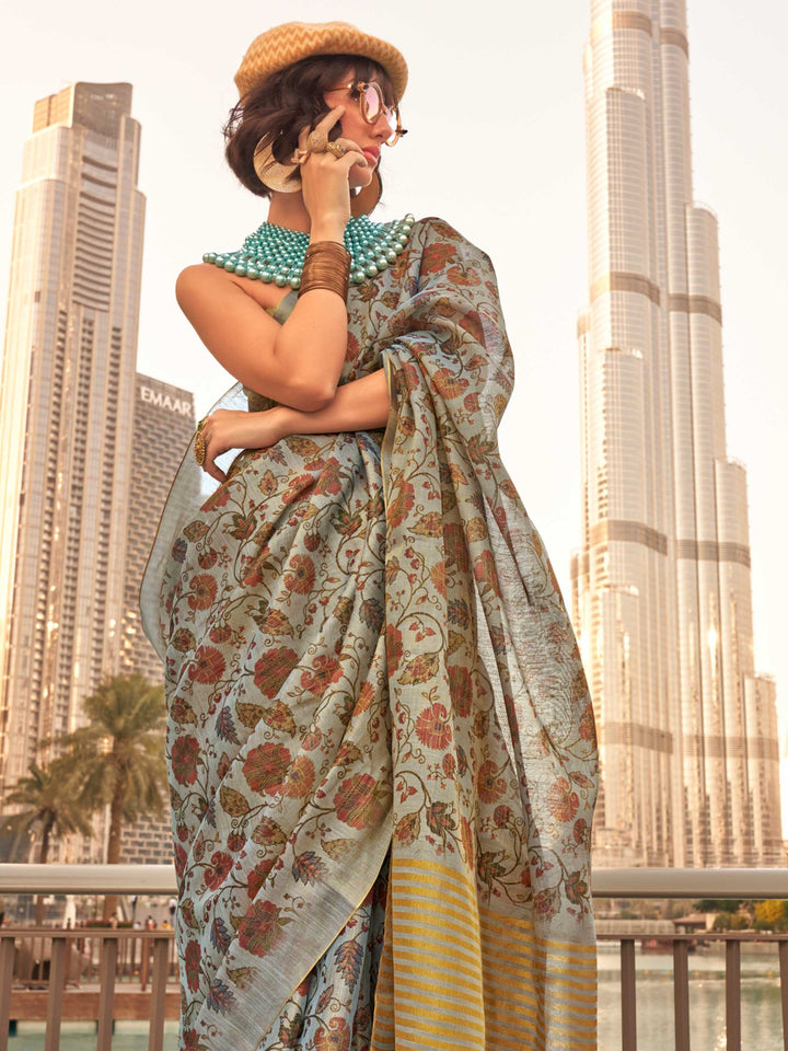 Powder Blue and Ivory zari tissue saree with printed floral motifs and zari pallu This image captures the side angle view showcasing blouse styling and zari border detail, ideal for visualizing festive elegance, designer appeal, and modern styling inspiration. Perfect for online shoppers seeking detailed previews before purchase, enhancing saree visual merchandising and SEO-rich product display strategy.