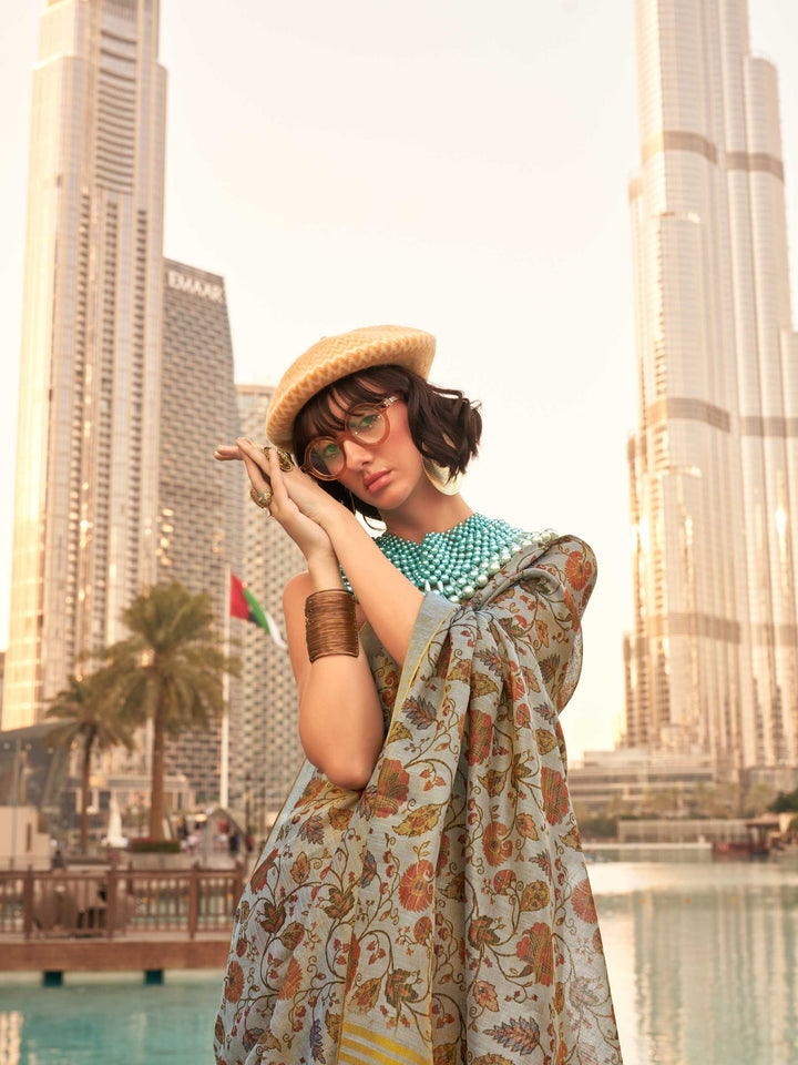 Powder Blue and Ivory zari tissue saree with printed floral motifs and zari pallu This image captures the model styling perspective with complete saree ensemble displayed, ideal for visualizing festive elegance, designer appeal, and modern styling inspiration. Perfect for online shoppers seeking detailed previews before purchase, enhancing saree visual merchandising and SEO-rich product display strategy.