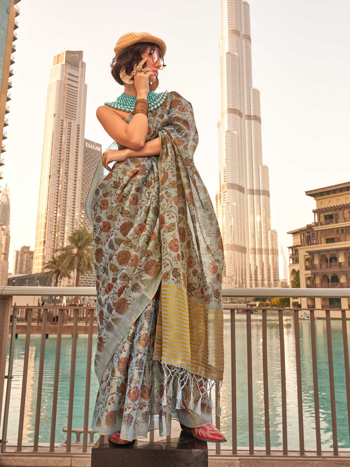 Powder Blue and Ivory zari tissue saree with printed floral motifs and zari pallu This image captures the front drape view highlighting pallu fall and pleats alignment, ideal for visualizing festive elegance, designer appeal, and modern styling inspiration. Perfect for online shoppers seeking detailed previews before purchase, enhancing saree visual merchandising and SEO-rich product display strategy.