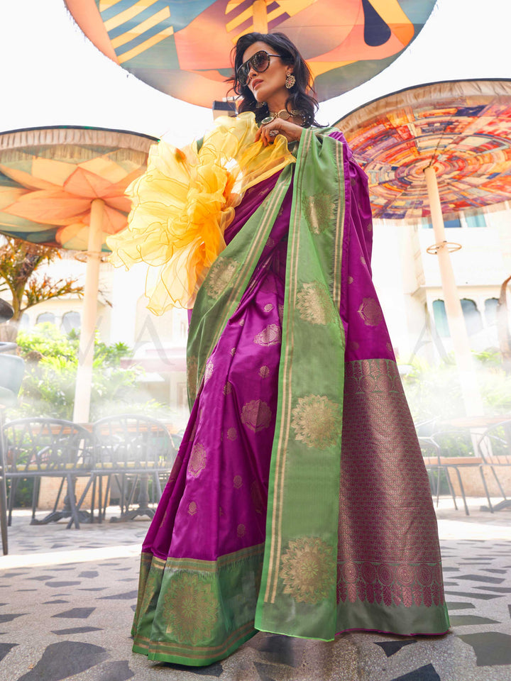 Magenta–Green satin silk saree featuring woven zari mandala motifs, contrast pallu and elegant festive finish. Festive Magenta–Green saree in soft satin silk with intricate weaving and a graceful two-tone blend.