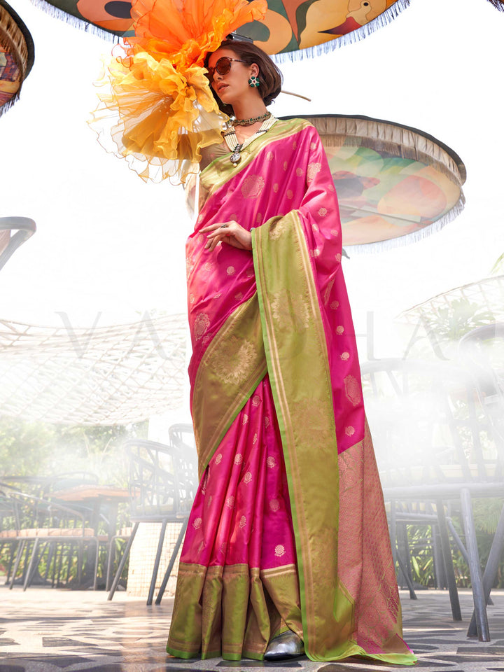 Rani Pink–Leaf Green satin silk saree featuring woven zari mandala motifs, contrast pallu and elegant festive finish. Festive Rani Pink–Leaf Green saree in soft satin silk with intricate weaving and a graceful two-tone blend.