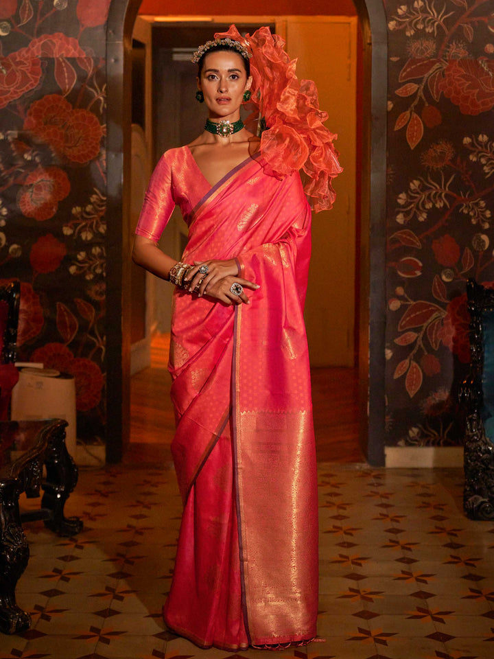 Peacock Blue–Gold banarasi satin silk saree with rich woven zari work and golden pallu styled for weddings. Model in Peacock Blue–Gold silk saree featuring temple-inspired zari buta and traditional border..