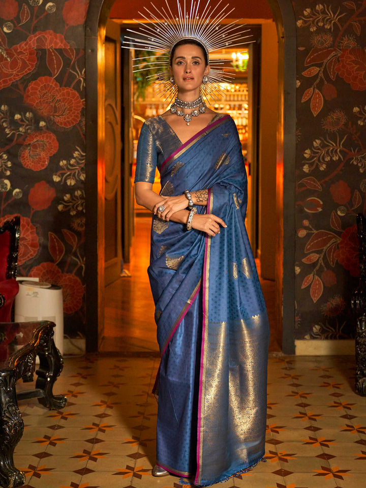 Midnight Blue–Gold banarasi satin silk saree with rich woven zari work and golden pallu styled for weddings. Model in Midnight Blue–Gold silk saree featuring temple-inspired zari buta and traditional border..