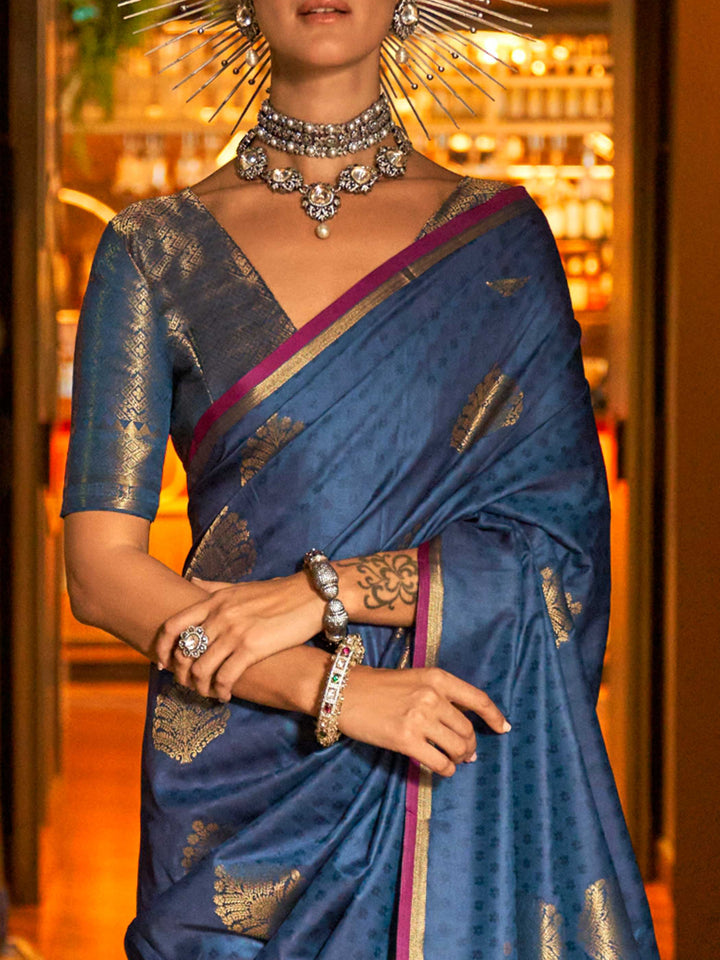 Midnight Blue–Gold silk saree photographed in heritage setting with antique floor and floral wallpaper. Back fall view showing the dramatic zari pallu and matched blouse of Midnight Blue–Gold saree..