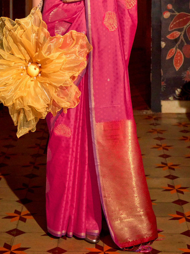 Banarasi satin saree in Purple–Rose Gold styled with heirloom jewelry and festive decor. Ornate pallu with golden motifs set against Purple–Rose Gold satin silk for regal presence..