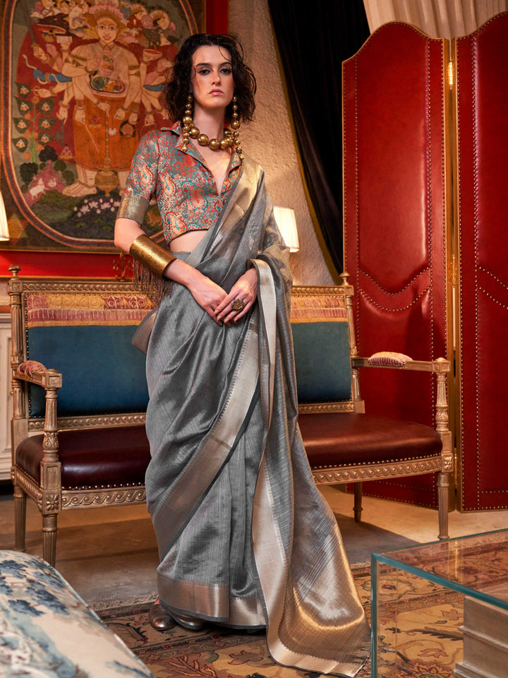 Soft Silver Grey chiffon saree with Platinum pallu and zari accents This image captures the front drape view highlighting pallu fall and pleats alignment, ideal for visualizing festive elegance, designer appeal, and modern styling inspiration. Perfect for online shoppers seeking detailed previews before purchase, enhancing saree visual merchandising and SEO-rich product display strategy.