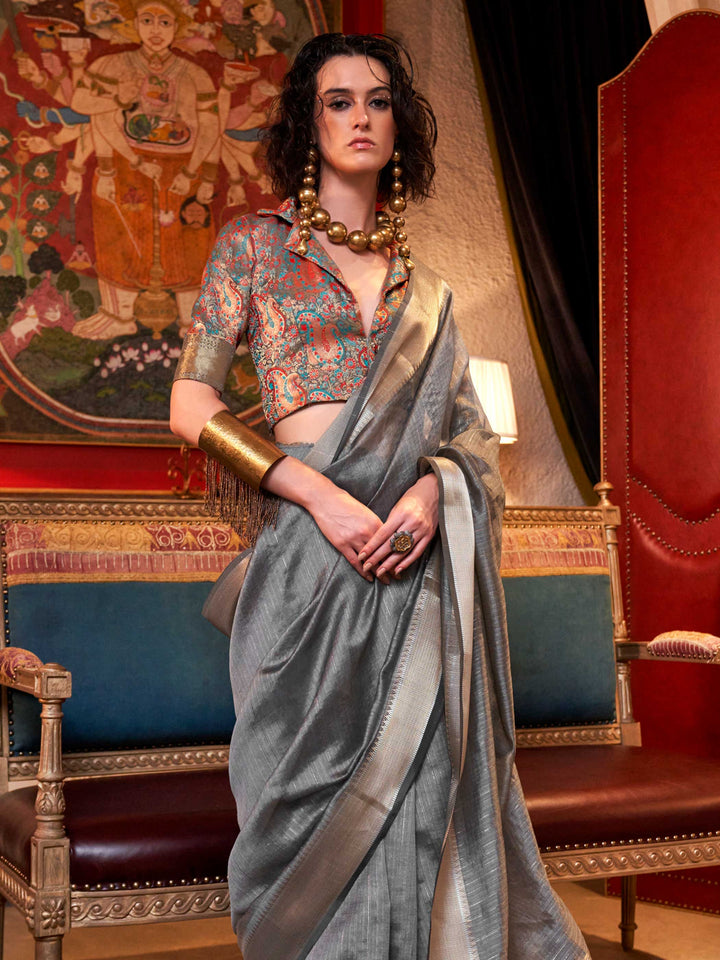 Soft Silver Grey chiffon saree with Platinum pallu and zari accents This image captures the side angle view showcasing blouse styling and zari border detail, ideal for visualizing festive elegance, designer appeal, and modern styling inspiration. Perfect for online shoppers seeking detailed previews before purchase, enhancing saree visual merchandising and SEO-rich product display strategy.