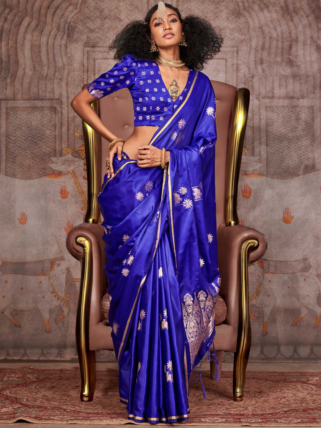 Royal Blue–Silver satin silk saree with jacquard woven motifs and floral zari detailing. Perfect partywear or reception look with embroidered blouse and traditional drape, ideal for festive fashion styling. Royal Blue–Silver satin silk saree with jacquard woven motifs and floral zari detailing. Perfect partywear or reception look with embroidered blouse and traditional drape, ideal for festive fashion styling..