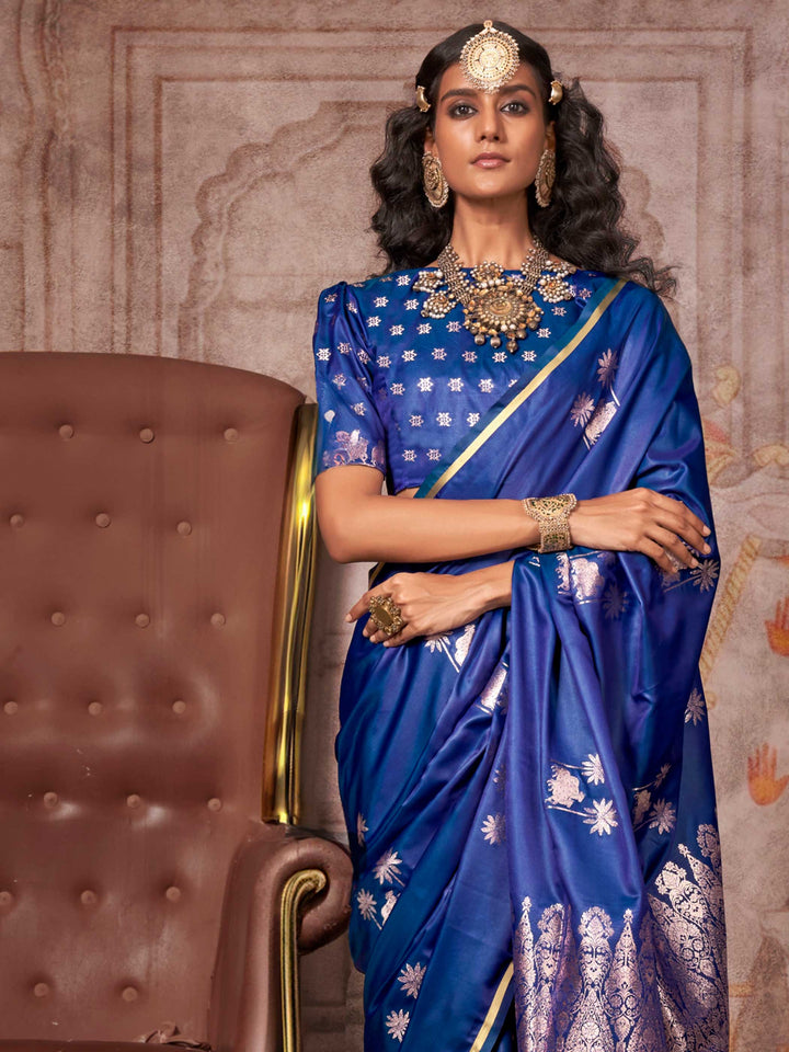 Navy Blue–Rose Gold satin silk saree with jacquard woven motifs and floral zari detailing. Perfect partywear or reception look with embroidered blouse and traditional drape, ideal for festive fashion styling. Navy Blue–Rose Gold satin silk saree with jacquard woven motifs and floral zari detailing. Perfect partywear or reception look with embroidered blouse and traditional drape, ideal for festive fashion styling..