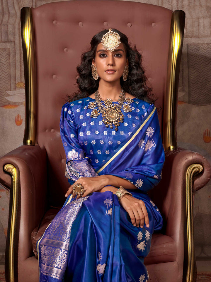 Navy Blue–Rose Gold satin silk saree with jacquard woven motifs and floral zari detailing. Perfect partywear or reception look with embroidered blouse and traditional drape, ideal for festive fashion styling. Navy Blue–Rose Gold satin silk saree with jacquard woven motifs and floral zari detailing. Perfect partywear or reception look with embroidered blouse and traditional drape, ideal for festive fashion styling..