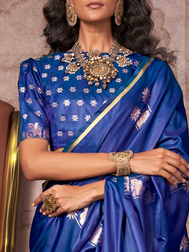 Navy Blue–Rose Gold satin silk saree with jacquard woven motifs and floral zari detailing. Perfect partywear or reception look with embroidered blouse and traditional drape, ideal for festive fashion styling. Navy Blue–Rose Gold satin silk saree with jacquard woven motifs and floral zari detailing. Perfect partywear or reception look with embroidered blouse and traditional drape, ideal for festive fashion styling..