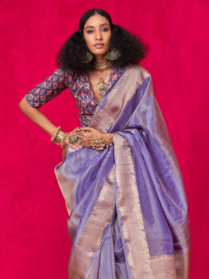 Lavender Grey–Rose Gold Zari tissue viscose silk saree with jacquard woven zari work, ideal for weddings, bridesmaids, and elegant evening events. Features tassel border and shimmering finish. Lavender Grey–Rose Gold Zari tissue viscose silk saree with jacquard woven zari work, ideal for weddings, bridesmaids, and elegant evening events. Features tassel border and shimmering finish..