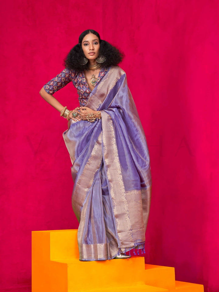 Lavender Grey–Rose Gold Zari tissue viscose silk saree with jacquard woven zari work, ideal for weddings, bridesmaids, and elegant evening events. Features tassel border and shimmering finish. Lavender Grey–Rose Gold Zari tissue viscose silk saree with jacquard woven zari work, ideal for weddings, bridesmaids, and elegant evening events. Features tassel border and shimmering finish..