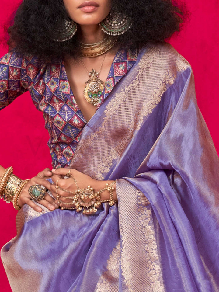 Lavender Grey–Rose Gold Zari tissue viscose silk saree with jacquard woven zari work, ideal for weddings, bridesmaids, and elegant evening events. Features tassel border and shimmering finish. Lavender Grey–Rose Gold Zari tissue viscose silk saree with jacquard woven zari work, ideal for weddings, bridesmaids, and elegant evening events. Features tassel border and shimmering finish..