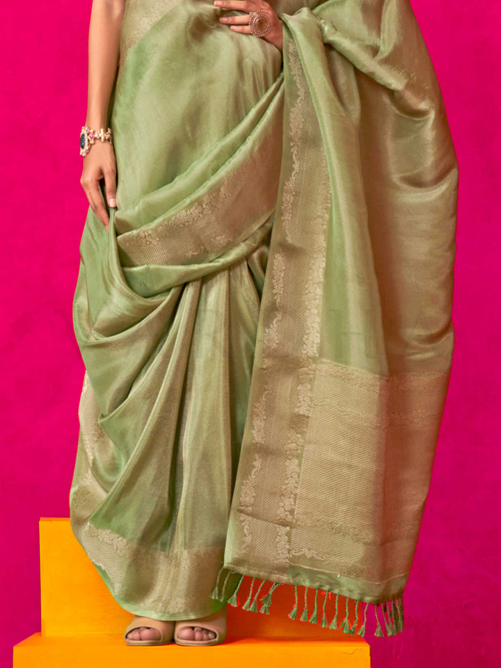 Sage Green–Olive Zari tissue viscose silk saree with jacquard woven zari work, ideal for weddings, bridesmaids, and elegant evening events. Features tassel border and shimmering finish. Sage Green–Olive Zari tissue viscose silk saree with jacquard woven zari work, ideal for weddings, bridesmaids, and elegant evening events. Features tassel border and shimmering finish..