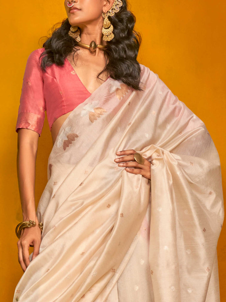 Ivory Cream–Peach Pink feathersoft tussar silk saree featuring woven lotus motifs and soft pallu, styled for festive rituals with a breathable finish. Ivory Cream–Peach Pink feathersoft tussar silk saree featuring woven lotus motifs and soft pallu, styled for festive rituals with a breathable finish..