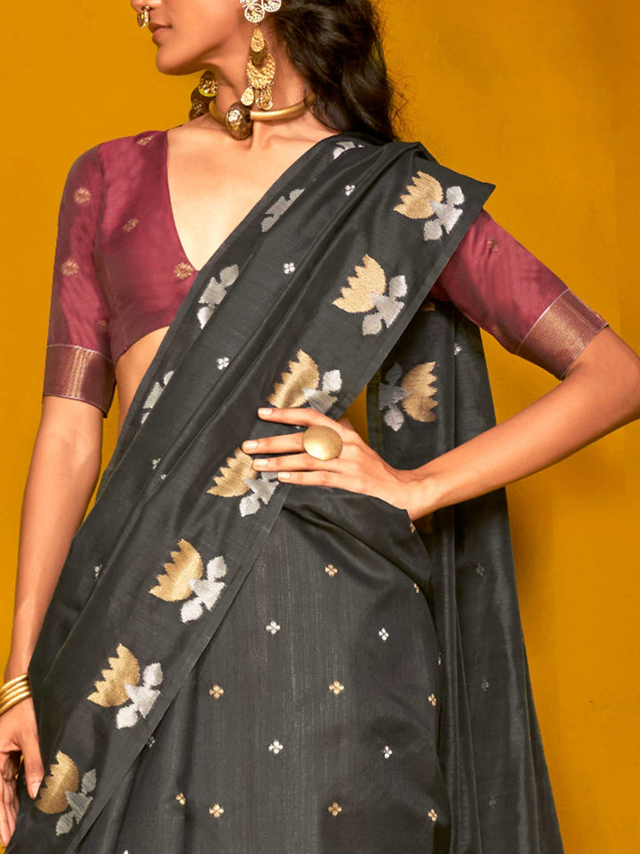 Charcoal Black–Wine Purple feathersoft tussar silk saree featuring woven lotus motifs and soft pallu, styled for festive rituals with a breathable finish. Charcoal Black–Wine Purple feathersoft tussar silk saree featuring woven lotus motifs and soft pallu, styled for festive rituals with a breathable finish..