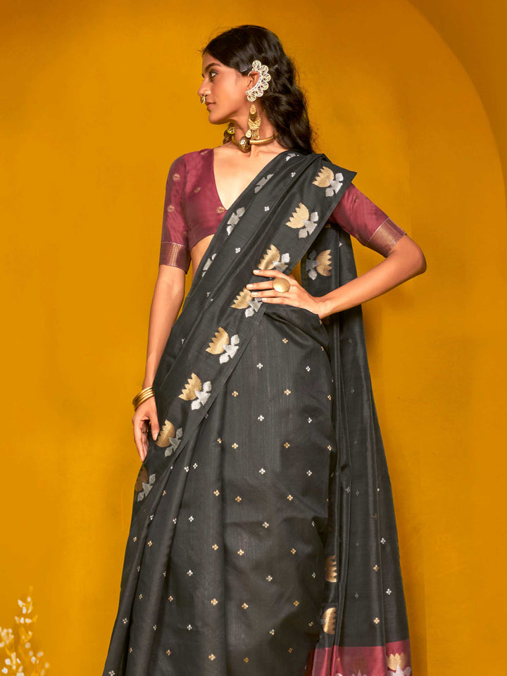 Charcoal Black–Wine Purple feathersoft tussar silk saree featuring woven lotus motifs and soft pallu, styled for festive rituals with a breathable finish. Charcoal Black–Wine Purple feathersoft tussar silk saree featuring woven lotus motifs and soft pallu, styled for festive rituals with a breathable finish..