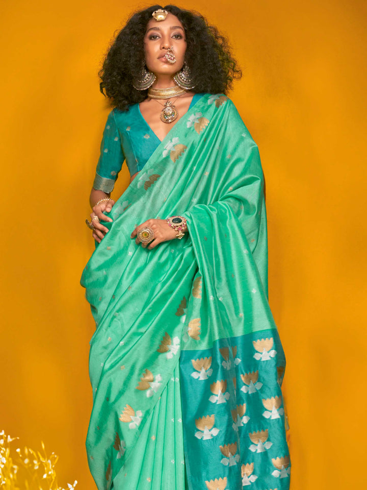 Seafoam Green–Teal Blue feathersoft tussar silk saree featuring woven lotus motifs and soft pallu, styled for festive rituals with a breathable finish. Seafoam Green–Teal Blue feathersoft tussar silk saree featuring woven lotus motifs and soft pallu, styled for festive rituals with a breathable finish..