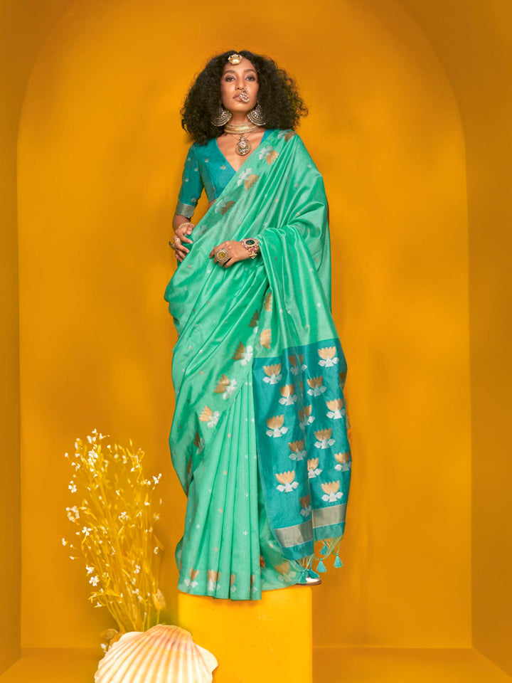 Seafoam Green–Teal Blue feathersoft tussar silk saree featuring woven lotus motifs and soft pallu, styled for festive rituals with a breathable finish. Seafoam Green–Teal Blue feathersoft tussar silk saree featuring woven lotus motifs and soft pallu, styled for festive rituals with a breathable finish..