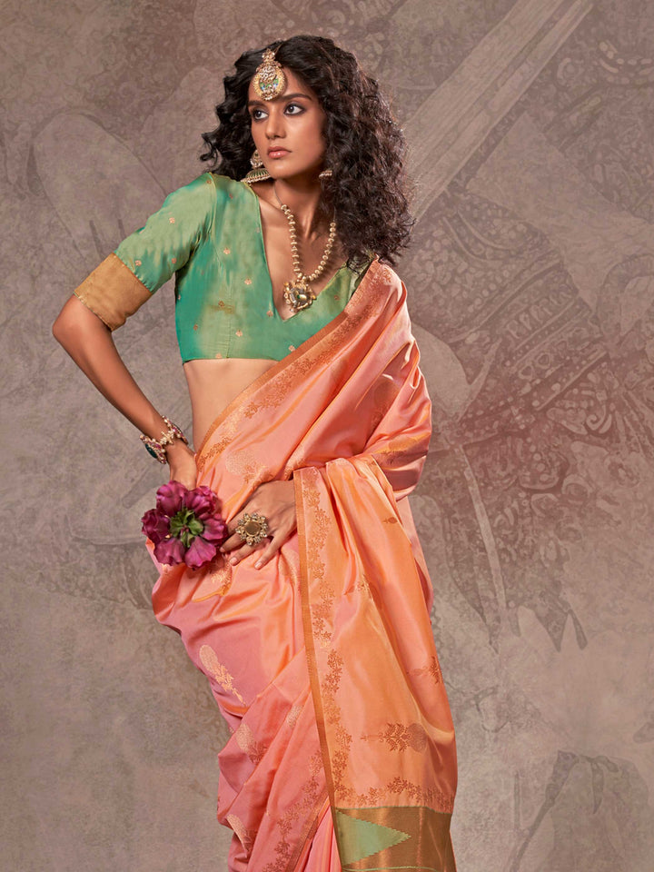 Peach Coral–Gold Green two-tone satin silk saree with woven zari work, styled for bridal wedding ceremonies with jacquard pattern and contrast pallu elegance. Peach Coral–Gold Green two-tone satin silk saree with woven zari work, styled for bridal wedding ceremonies with jacquard pattern and contrast pallu elegance..