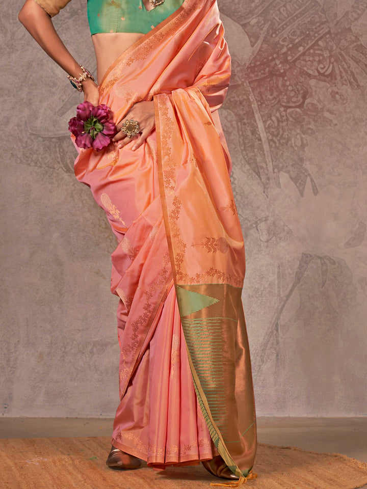 Peach Coral–Gold Green two-tone satin silk saree with woven zari work, styled for bridal wedding ceremonies with jacquard pattern and contrast pallu elegance. Peach Coral–Gold Green two-tone satin silk saree with woven zari work, styled for bridal wedding ceremonies with jacquard pattern and contrast pallu elegance..