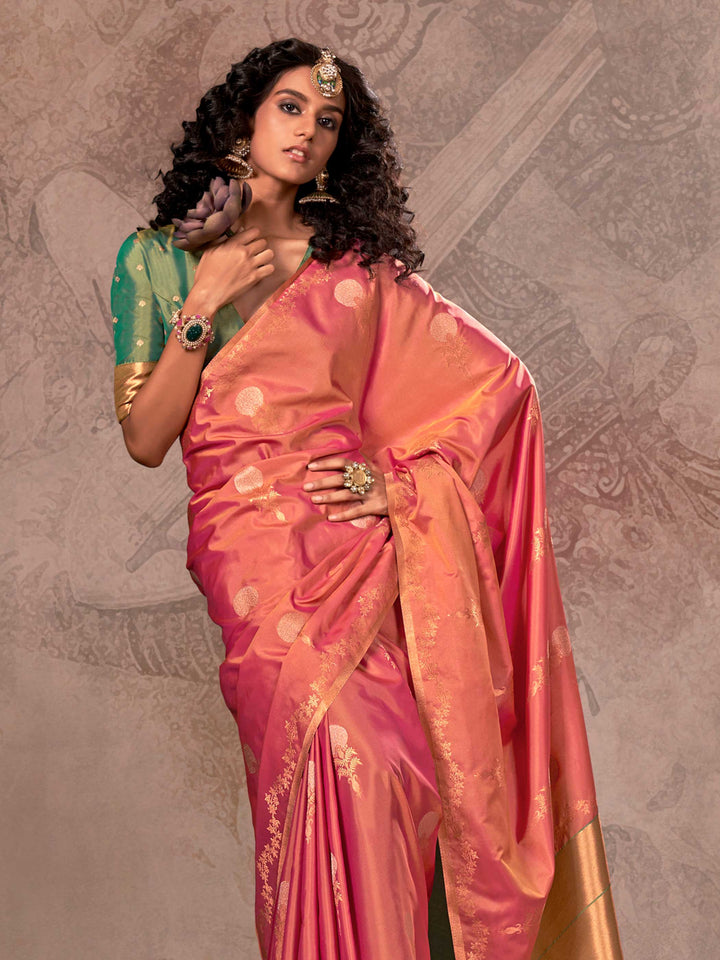 Rani Pink–Golden Peach two-tone satin silk saree with woven zari work, styled for bridal wedding ceremonies with jacquard pattern and contrast pallu elegance. Rani Pink–Golden Peach two-tone satin silk saree with woven zari work, styled for bridal wedding ceremonies with jacquard pattern and contrast pallu elegance..