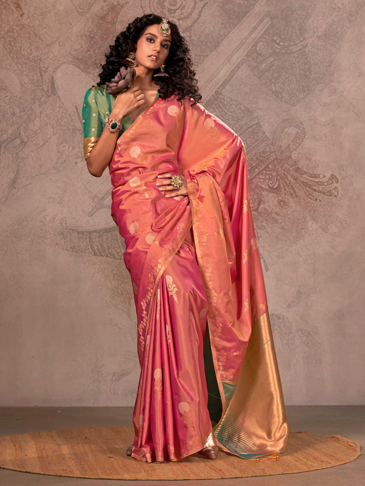 Rani Pink–Golden Peach two-tone satin silk saree with woven zari work, styled for bridal wedding ceremonies with jacquard pattern and contrast pallu elegance. Rani Pink–Golden Peach two-tone satin silk saree with woven zari work, styled for bridal wedding ceremonies with jacquard pattern and contrast pallu elegance..