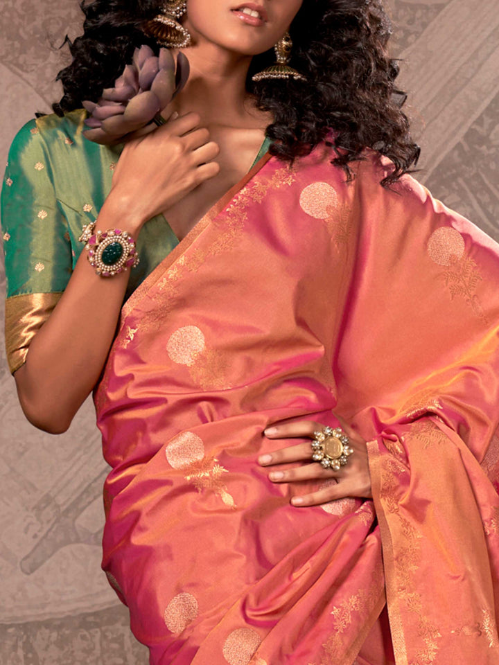 Rani Pink–Golden Peach two-tone satin silk saree with woven zari work, styled for bridal wedding ceremonies with jacquard pattern and contrast pallu elegance. Rani Pink–Golden Peach two-tone satin silk saree with woven zari work, styled for bridal wedding ceremonies with jacquard pattern and contrast pallu elegance..