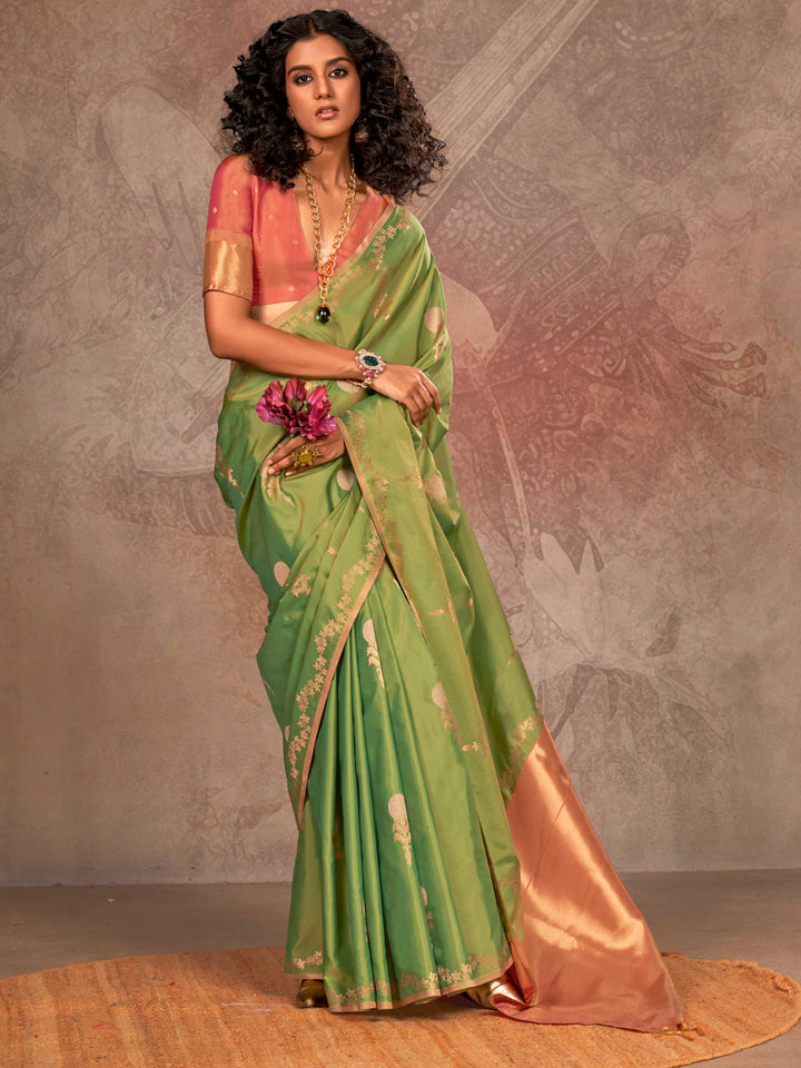Leaf Green–Copper Peach two-tone satin silk saree with woven zari work, styled for bridal wedding ceremonies with jacquard pattern and contrast pallu elegance. Leaf Green–Copper Peach two-tone satin silk saree with woven zari work, styled for bridal wedding ceremonies with jacquard pattern and contrast pallu elegance..