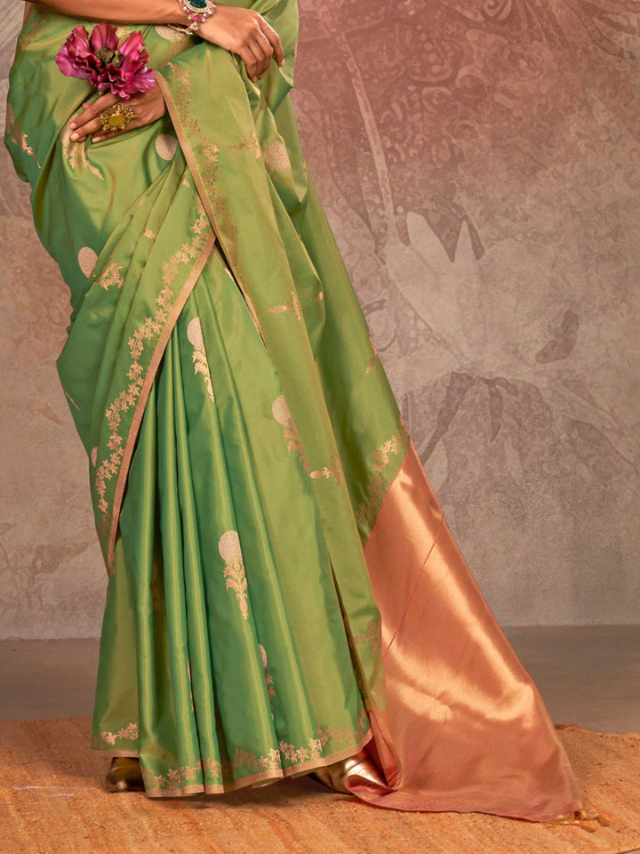 Leaf Green–Copper Peach two-tone satin silk saree with woven zari work, styled for bridal wedding ceremonies with jacquard pattern and contrast pallu elegance. Leaf Green–Copper Peach two-tone satin silk saree with woven zari work, styled for bridal wedding ceremonies with jacquard pattern and contrast pallu elegance..