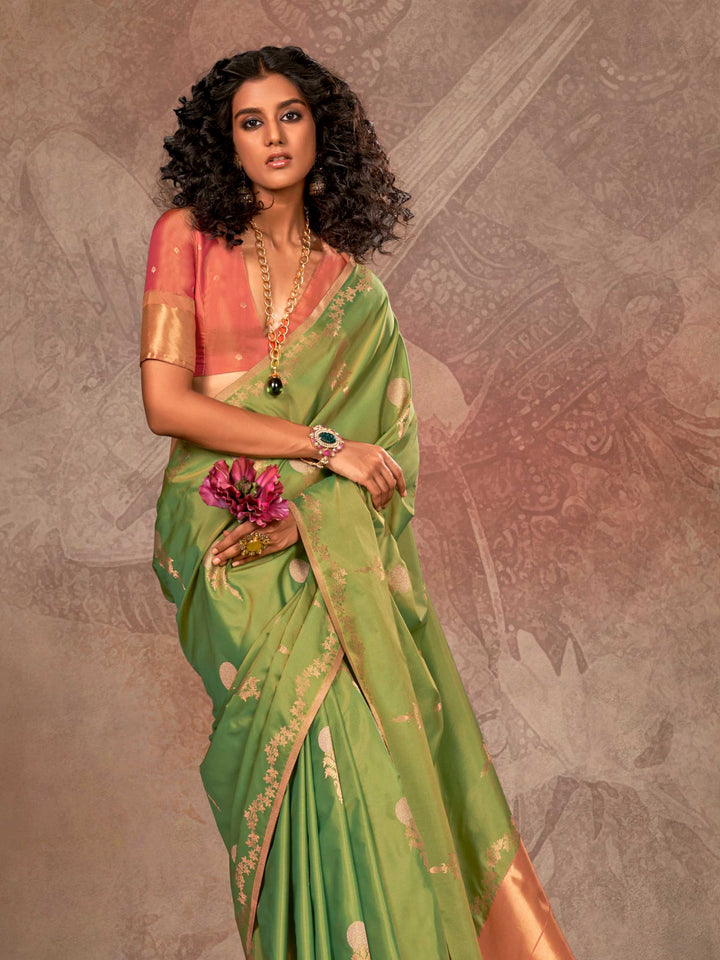 Leaf Green–Copper Peach two-tone satin silk saree with woven zari work, styled for bridal wedding ceremonies with jacquard pattern and contrast pallu elegance. Leaf Green–Copper Peach two-tone satin silk saree with woven zari work, styled for bridal wedding ceremonies with jacquard pattern and contrast pallu elegance..