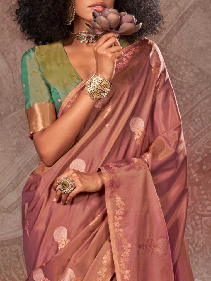 Dusty Rose–Gold Olive two-tone satin silk saree with woven zari work, styled for bridal wedding ceremonies with jacquard pattern and contrast pallu elegance. Dusty Rose–Gold Olive two-tone satin silk saree with woven zari work, styled for bridal wedding ceremonies with jacquard pattern and contrast pallu elegance..