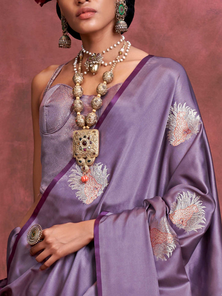 Plum Lavender–Lilac Silver satin silk saree with intricate jacquard zari motifs and metallic pallu, styled for wedding reception and festive bridal evenings with sculpted blouse elegance. Plum Lavender–Lilac Silver satin silk saree with intricate jacquard zari motifs and metallic pallu, styled for wedding reception and festive bridal evenings with sculpted blouse elegance..