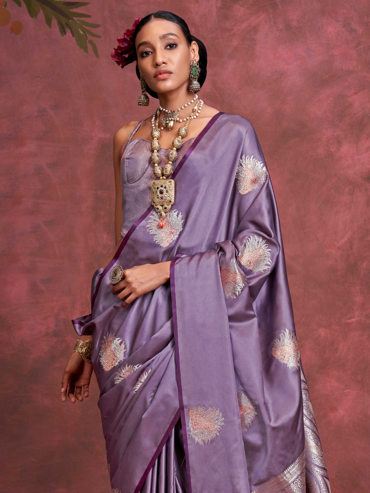 Plum Lavender–Lilac Silver satin silk saree with intricate jacquard zari motifs and metallic pallu, styled for wedding reception and festive bridal evenings with sculpted blouse elegance. Plum Lavender–Lilac Silver satin silk saree with intricate jacquard zari motifs and metallic pallu, styled for wedding reception and festive bridal evenings with sculpted blouse elegance..