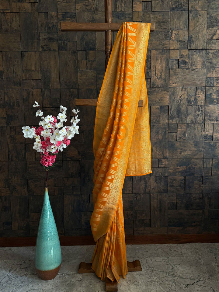 Mustard yellow soft georgette saree with antique gold zari woven border