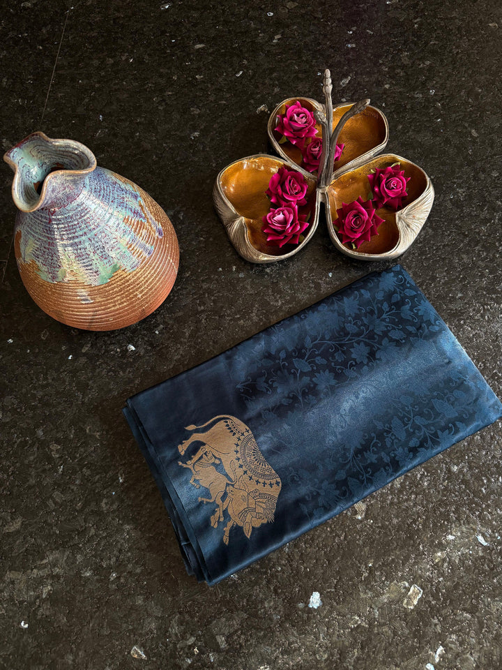 Evening wear satin saree in midnight tone with classic zari accents