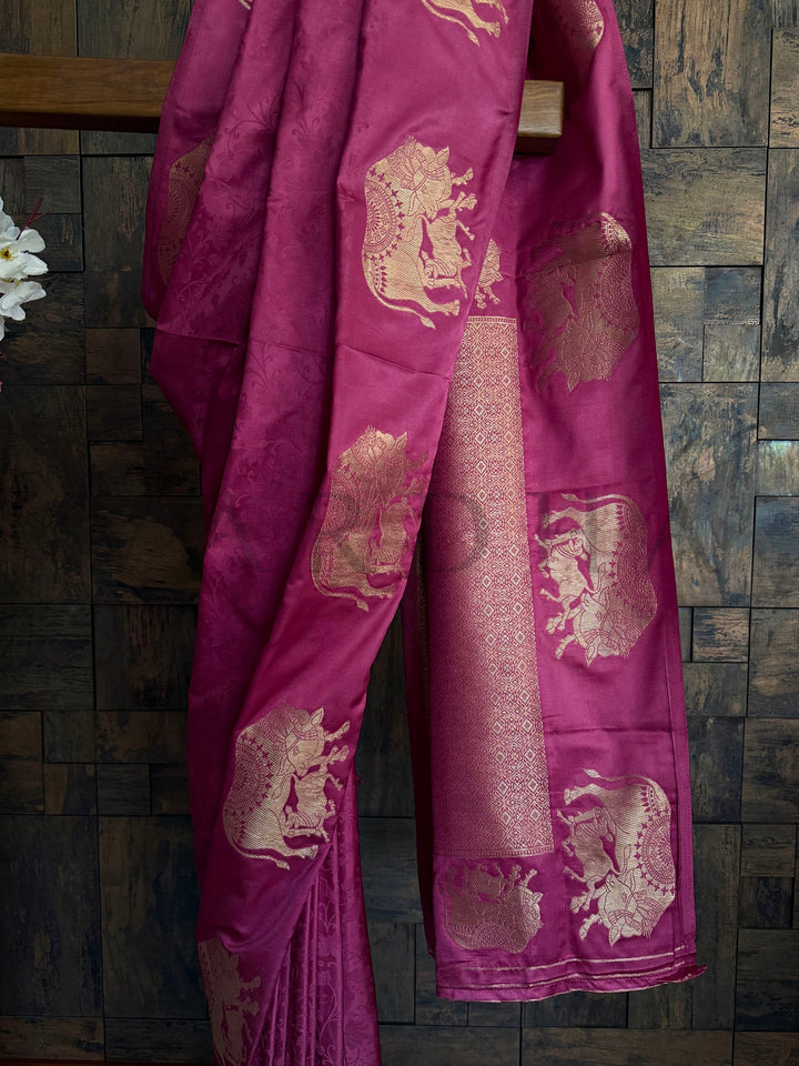 Smooth satin ethnic saree with rose gold accents and classic motifs