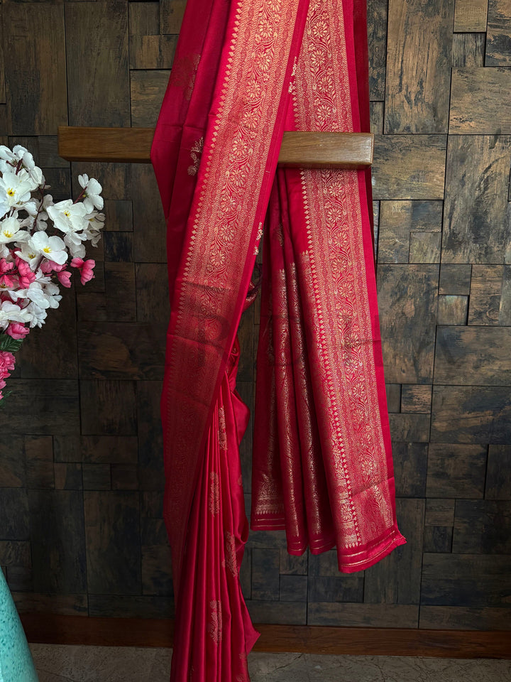 Crimson saree with unstitched blouse piece and soft traditional drape