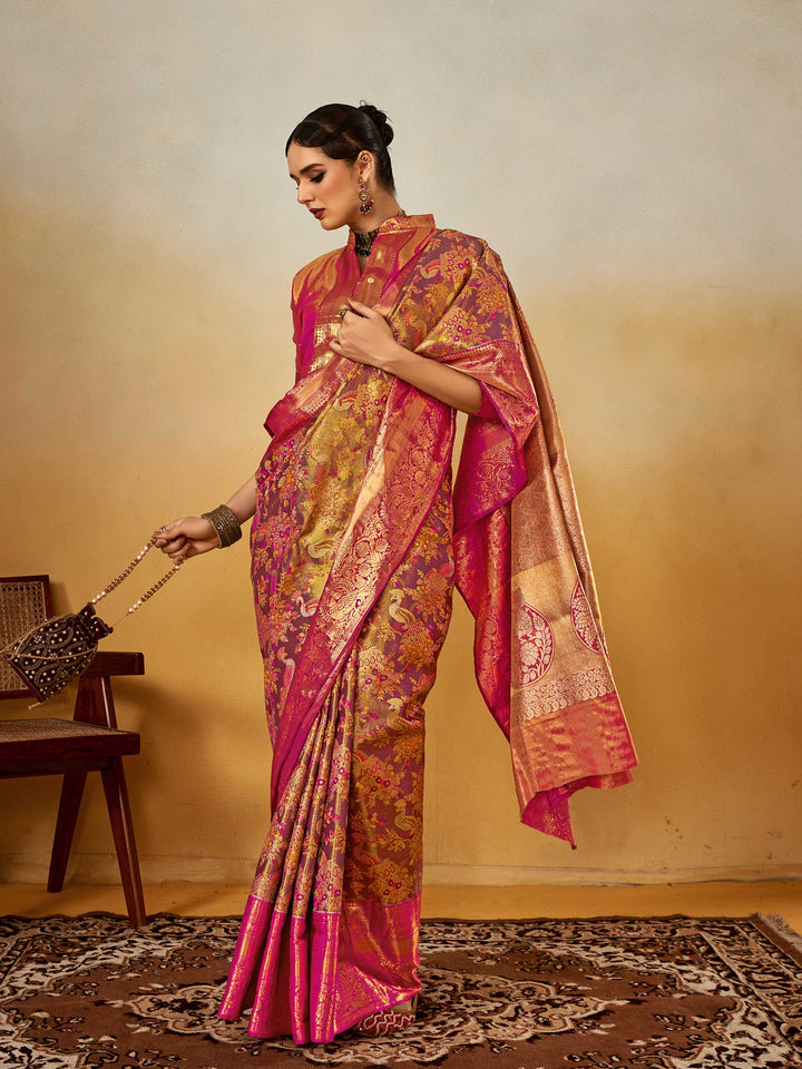 Magenta–Gold Banarasi satin silk saree with zari work and woven parrot motifs, styled for traditional Indian wedding rituals with luxury finish.