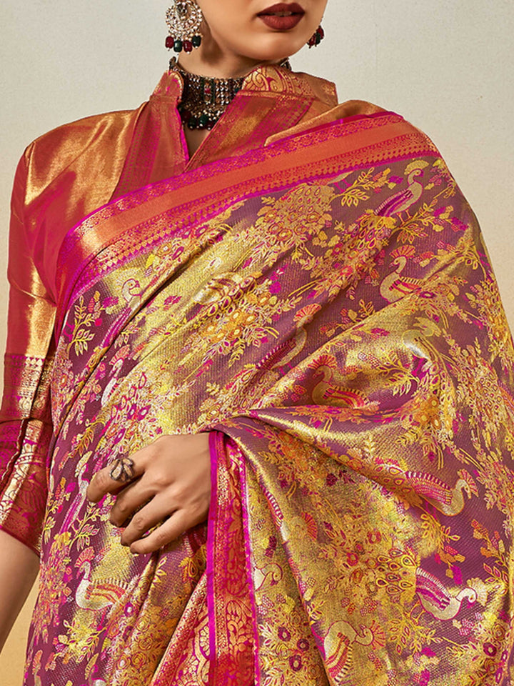 Magenta–Gold Banarasi satin silk saree with zari work and woven parrot motifs, styled for traditional Indian wedding rituals with luxury finish. Magenta–Gold Banarasi satin silk saree with zari work and woven parrot motifs, styled for traditional Indian wedding rituals with luxury finish..