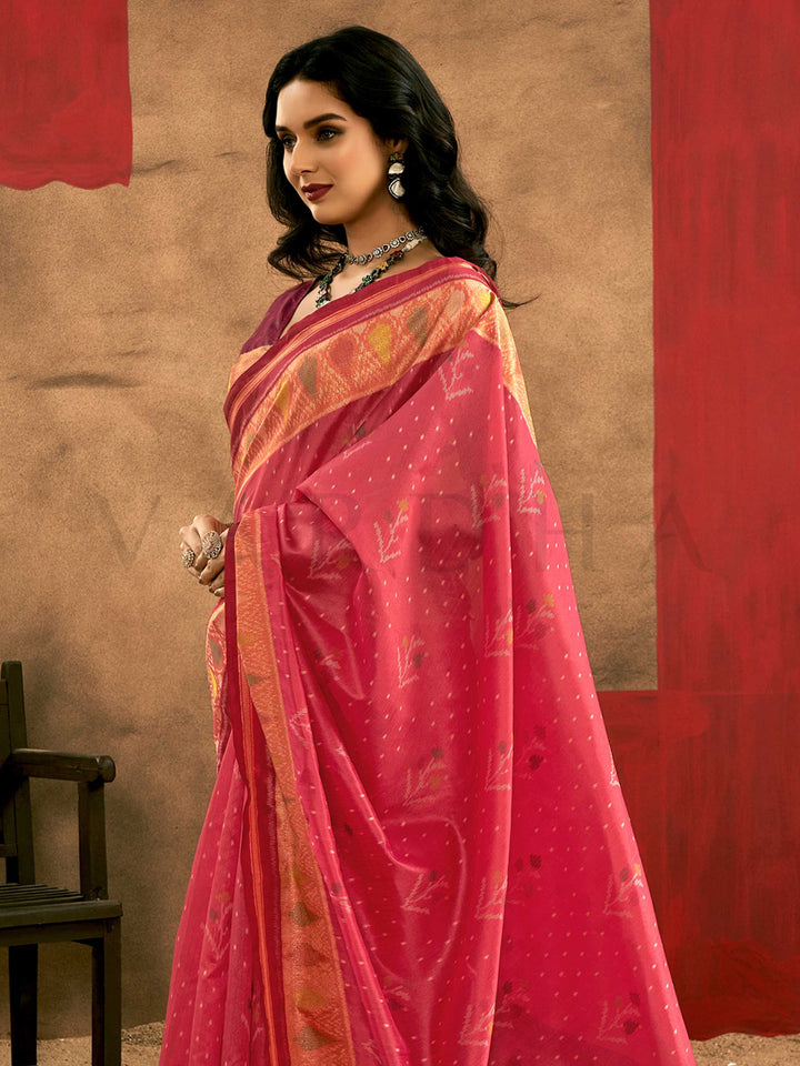 Crimson Pink–Burnt Orange Banarasi silk saree with Patola-inspired design and rich zari border, styled for wedding glamour and traditional elegance. Crimson Pink–Burnt Orange Banarasi silk saree with Patola-inspired design and rich zari border, styled for wedding glamour and traditional elegance..