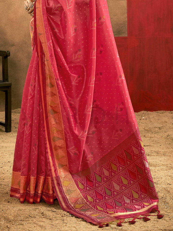 Crimson Pink–Burnt Orange Banarasi silk saree with Patola-inspired design and rich zari border, styled for wedding glamour and traditional elegance. Crimson Pink–Burnt Orange Banarasi silk saree with Patola-inspired design and rich zari border, styled for wedding glamour and traditional elegance..