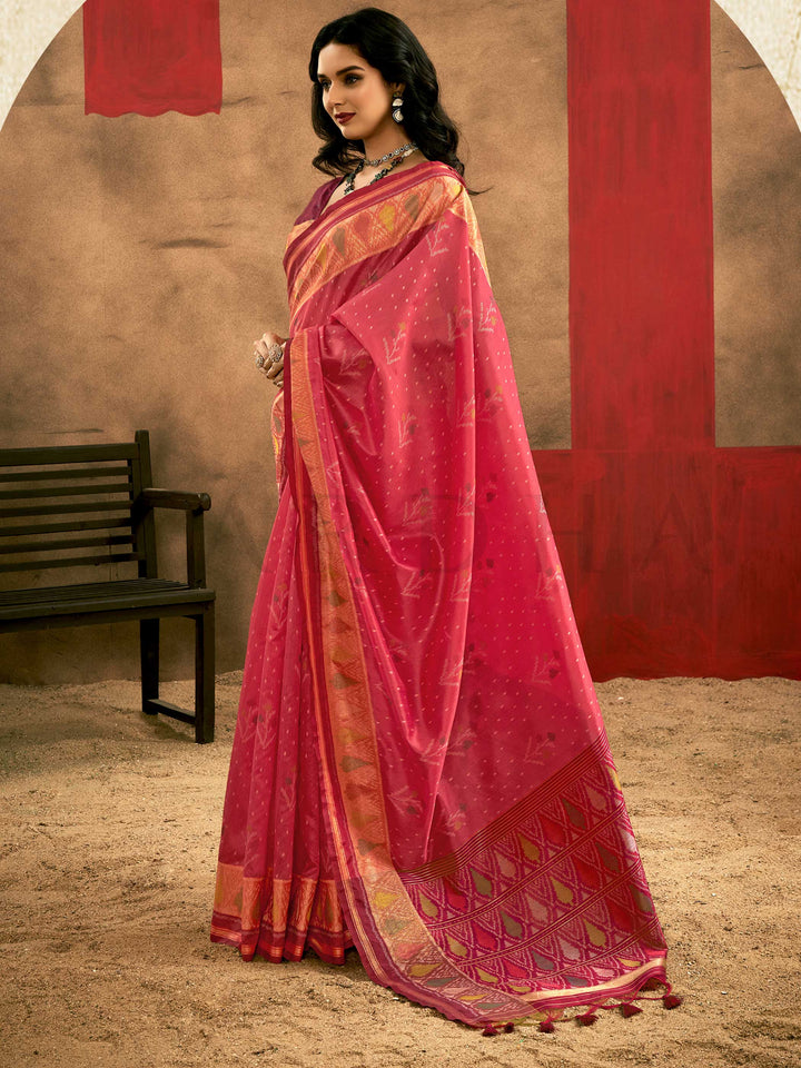 Crimson Pink–Burnt Orange Banarasi silk saree with Patola-inspired design and rich zari border, styled for wedding glamour and traditional elegance. Crimson Pink–Burnt Orange Banarasi silk saree with Patola-inspired design and rich zari border, styled for wedding glamour and traditional elegance..