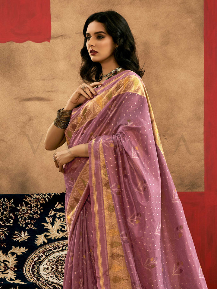 Lavender Mauve–Gold Banarasi silk saree with Patola-inspired design and rich zari border, styled for wedding glamour and traditional elegance. Lavender Mauve–Gold Banarasi silk saree with Patola-inspired design and rich zari border, styled for wedding glamour and traditional elegance..