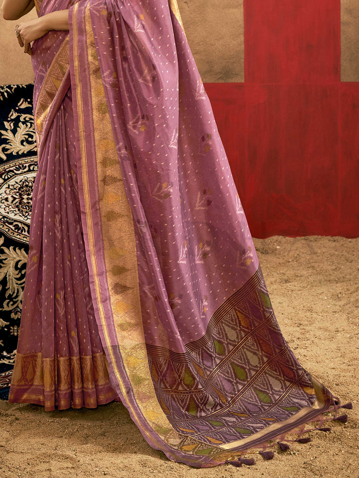 Lavender Mauve–Gold Banarasi silk saree with Patola-inspired design and rich zari border, styled for wedding glamour and traditional elegance. Lavender Mauve–Gold Banarasi silk saree with Patola-inspired design and rich zari border, styled for wedding glamour and traditional elegance..