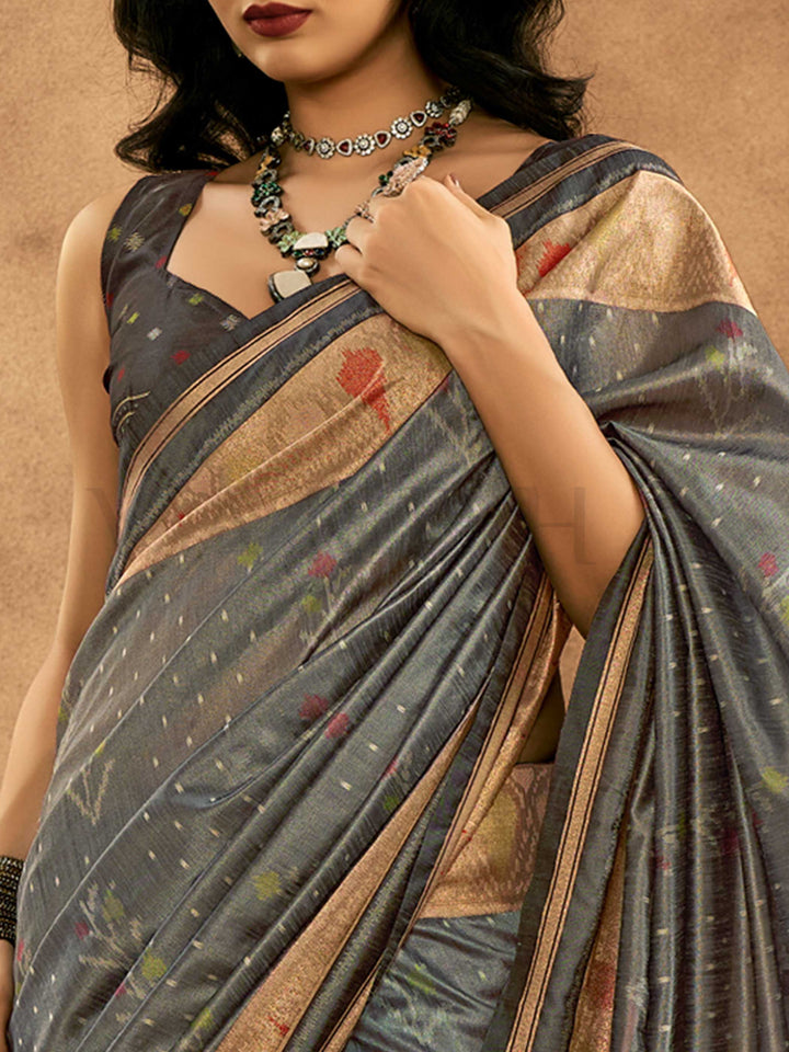 Slate Grey–Multi Zari Banarasi silk saree with Patola-inspired design and rich zari border, styled for wedding glamour and traditional elegance. Slate Grey–Multi Zari Banarasi silk saree with Patola-inspired design and rich zari border, styled for wedding glamour and traditional elegance..