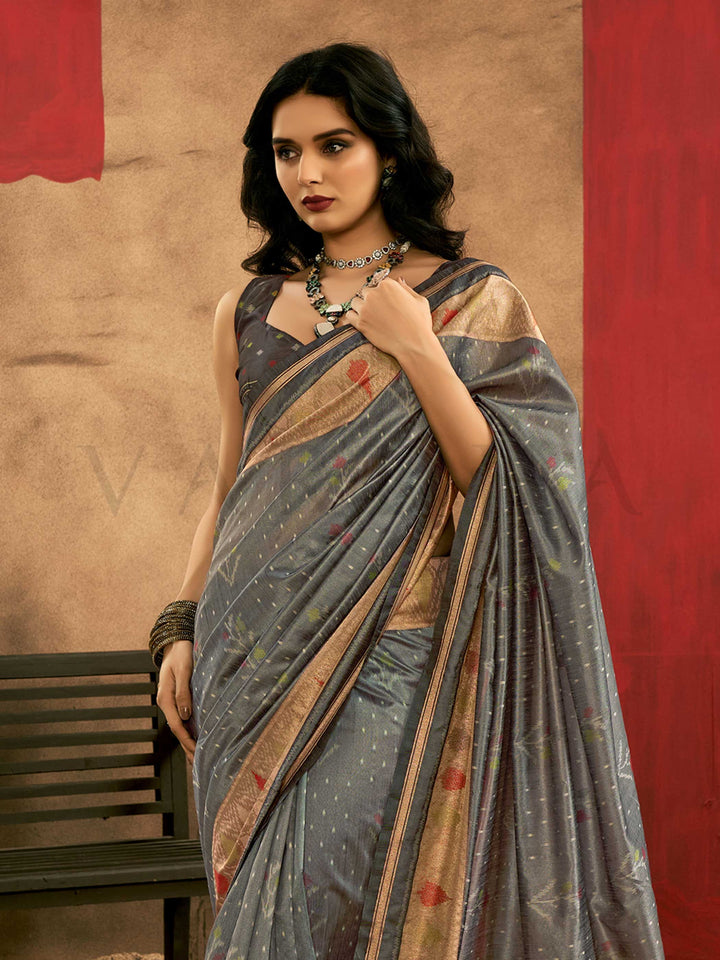Slate Grey–Multi Zari Banarasi silk saree with Patola-inspired design and rich zari border, styled for wedding glamour and traditional elegance. Slate Grey–Multi Zari Banarasi silk saree with Patola-inspired design and rich zari border, styled for wedding glamour and traditional elegance..
